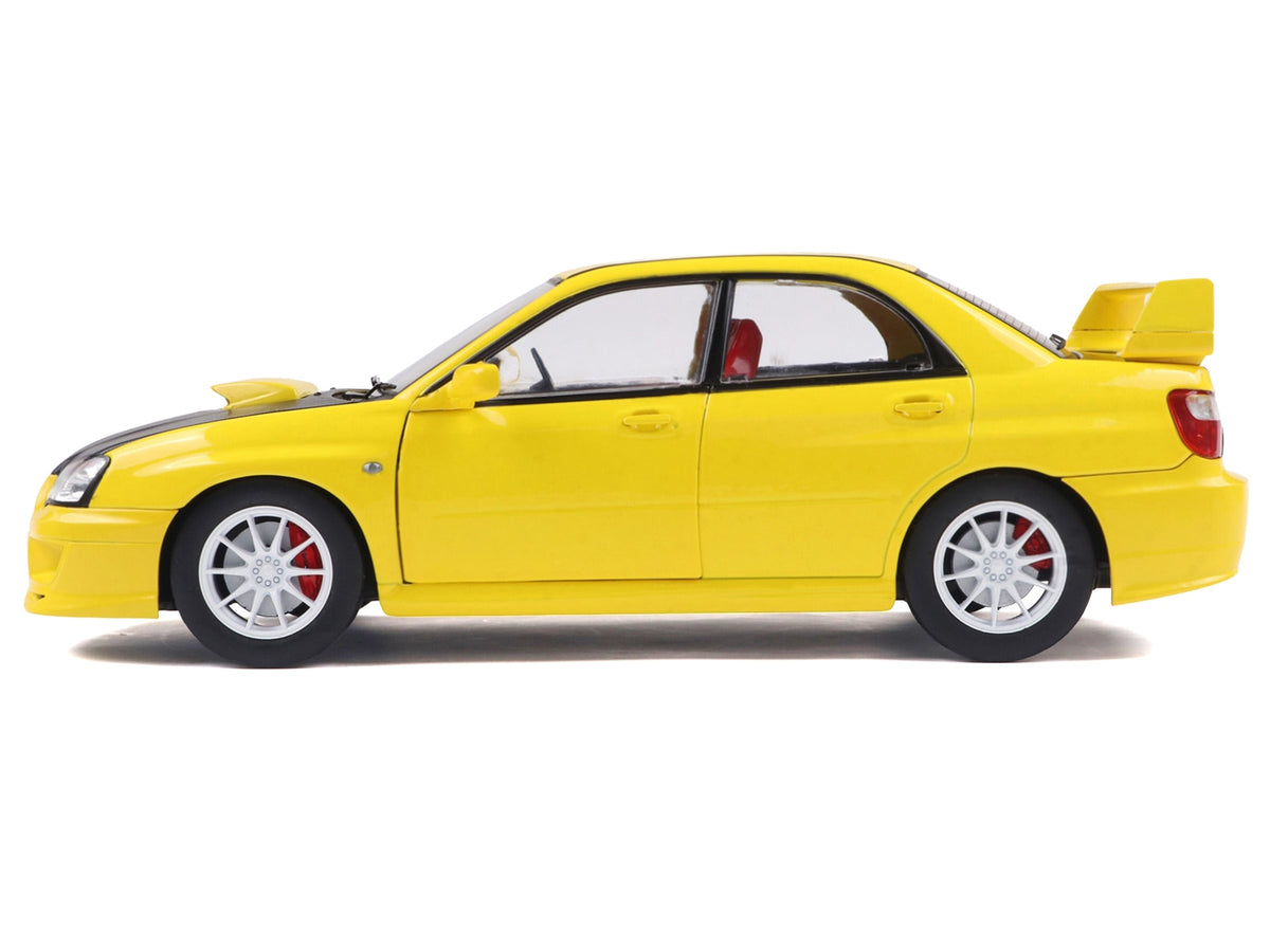 2003 Subaru Impreza WRX STI RHD yellow diecast model car with carbon hood, detailed replica by Solido in 1/18 scale.