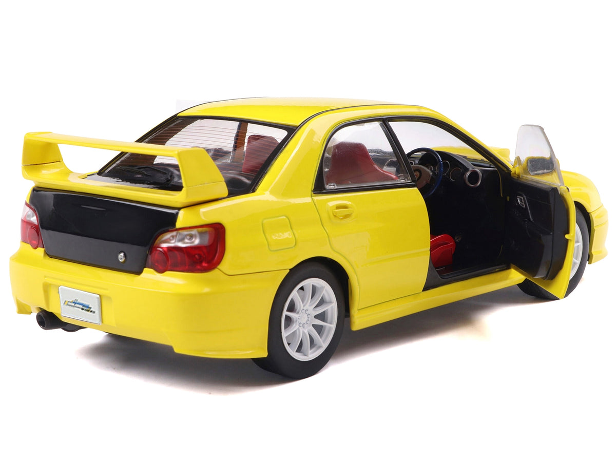 Yellow 2003 Subaru Impreza WRX STI RHD diecast model car by Solido, featuring a carbon hood, 1/18 scale, detailed collectible.