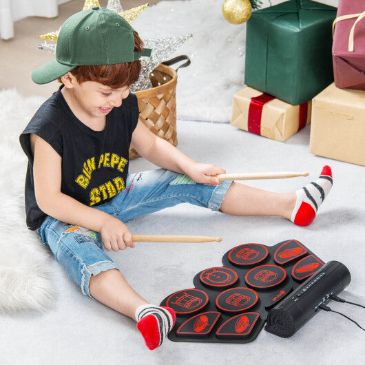 Red electronic drum set for kids by American Smart with two built-in stereo speakers, colorful toy percussion instrument.