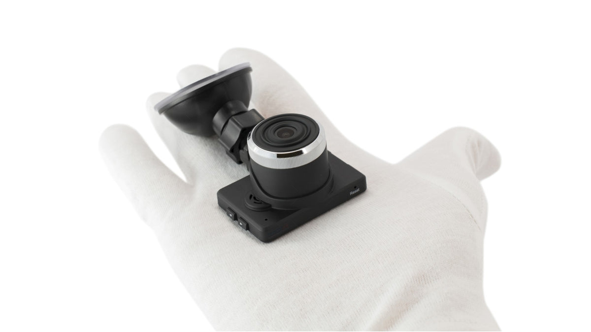 American Smart WB iDrive DVR camera mounted in vehicle dashboard with LCD screen, capturing video footage for in-car recording.