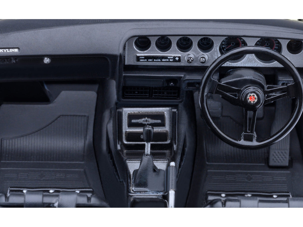 White 1/18 scale Nissan Skyline 2000GT-R KPGC110 tuned model car by Autoart, RHD, detailed collectible Nissan model.