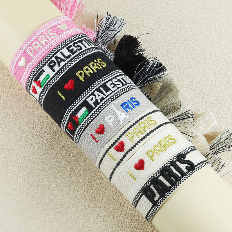 Embroidered Eiffel Tower woven wrist strap with ethnic style design, featuring Paris-themed motifs and colorful details.