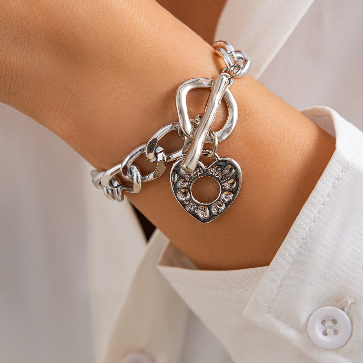 Lava hollowed out heart-shaped pendant necklace with punk metallic collarbone chain, eprolo jewelry set, close-up view of the pendant.