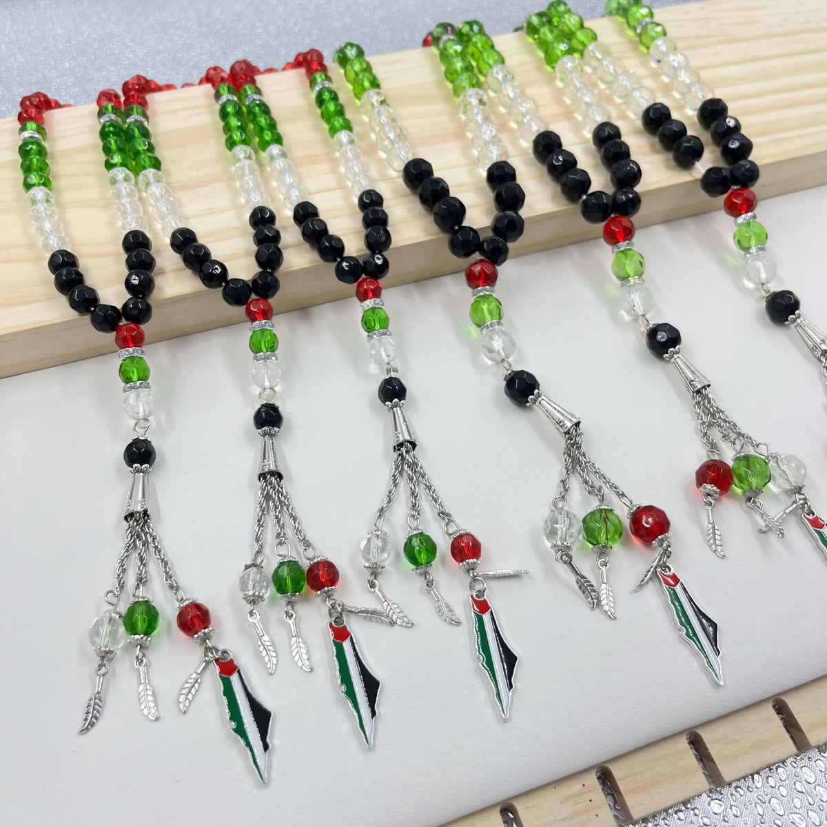 Eprolo 33 prayer beads with Palestinian flag colored crystal glass, featuring vibrant red, green, black, and white beads for spiritual practice