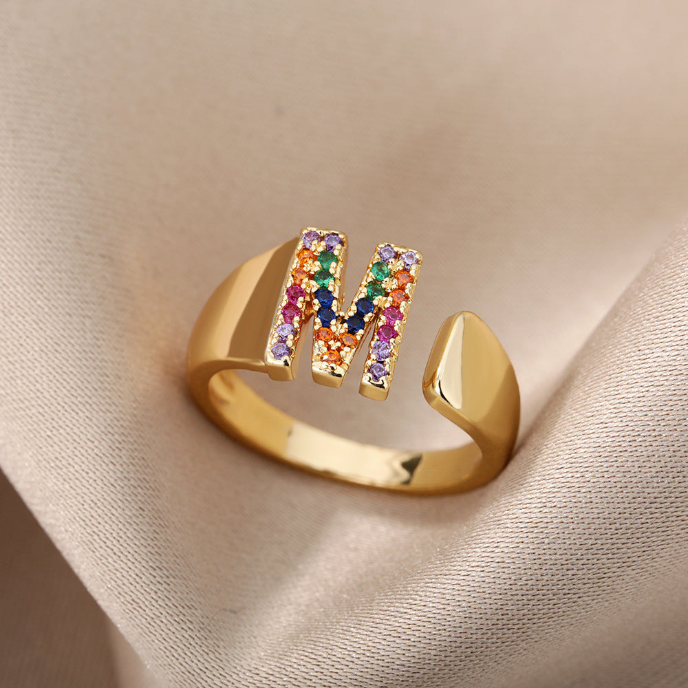 18K gold plated micro pave zircon letter ring featuring colorful stones and open design, showcasing a single alphabet letter.