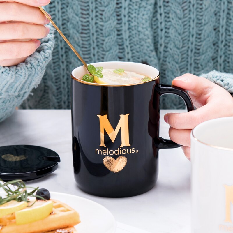 Eprolo 400ml black ceramic coffee mug with gold finger printing, gold handle, lid, and spoon, ideal for tea or coffee.