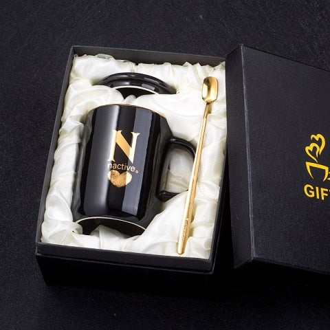 Eprolo 400ml black ceramic coffee mug with gold handle, lid, and spoon, featuring a creative gold fingerprint design.