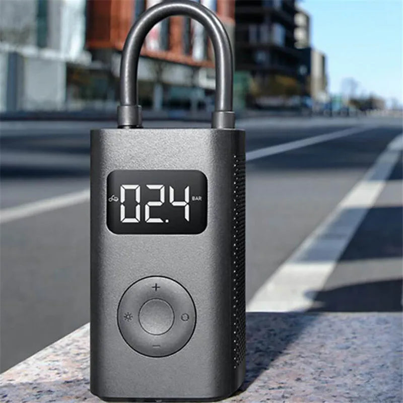 Xiaomi Mijia portable digital tire pressure inflator pump with LCD display for bikes, motorcycles, cars, and footballs.