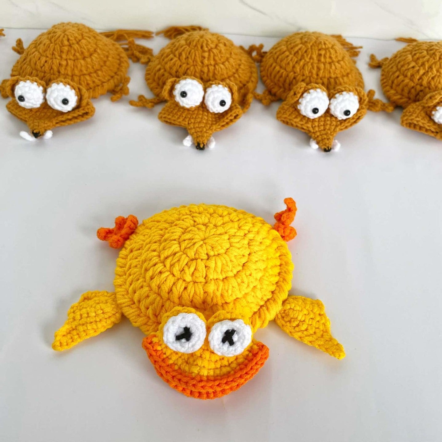 Handmade crochet turtle and squirrel animal coasters, heat-insulating pads for creative desk decor and home protection.