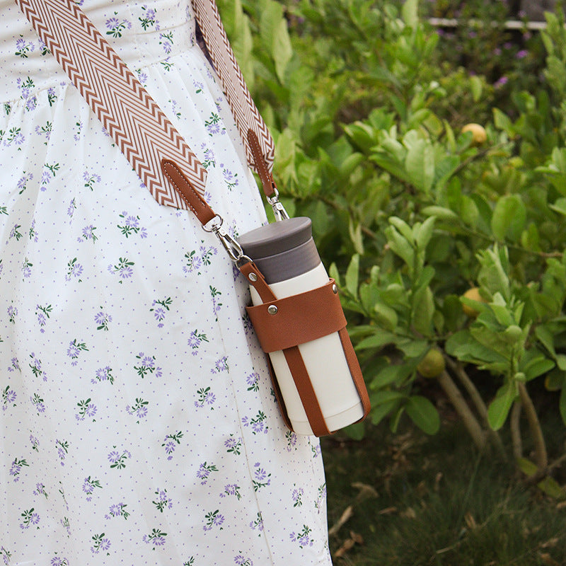 Eprolo outdoor insulated stainless steel cup with detachable woven shoulder strap and diagonal bottle cover for travel.