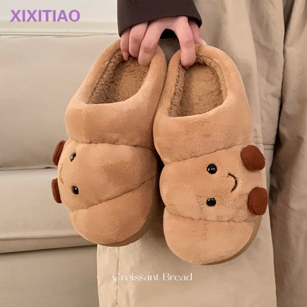 Pair of eprolo men's and women's cotton slippers shaped like cute croissant bread for cozy home wear.