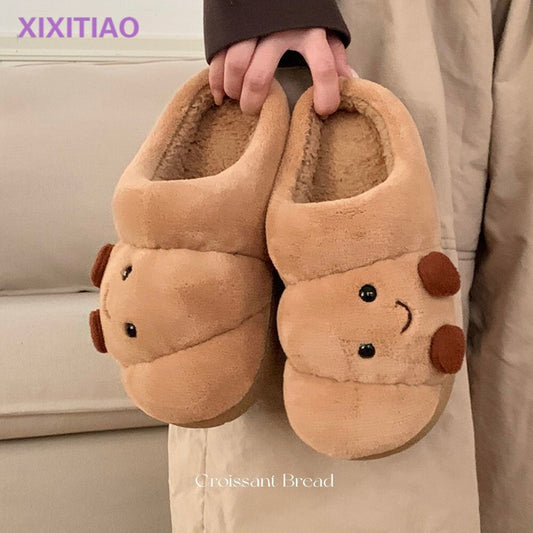 Pair of eprolo men's and women's cotton slippers shaped like cute croissant bread for cozy home wear.