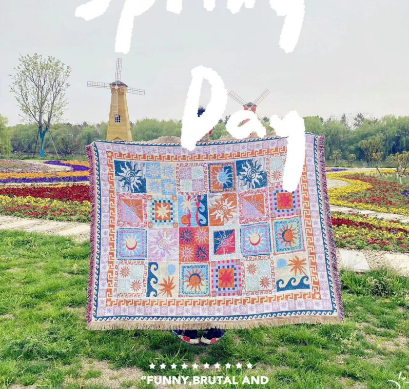 Eprolo multi-functional cotton blanket for camping, bedroom, and sofa, shown draped over a cozy living room setting.