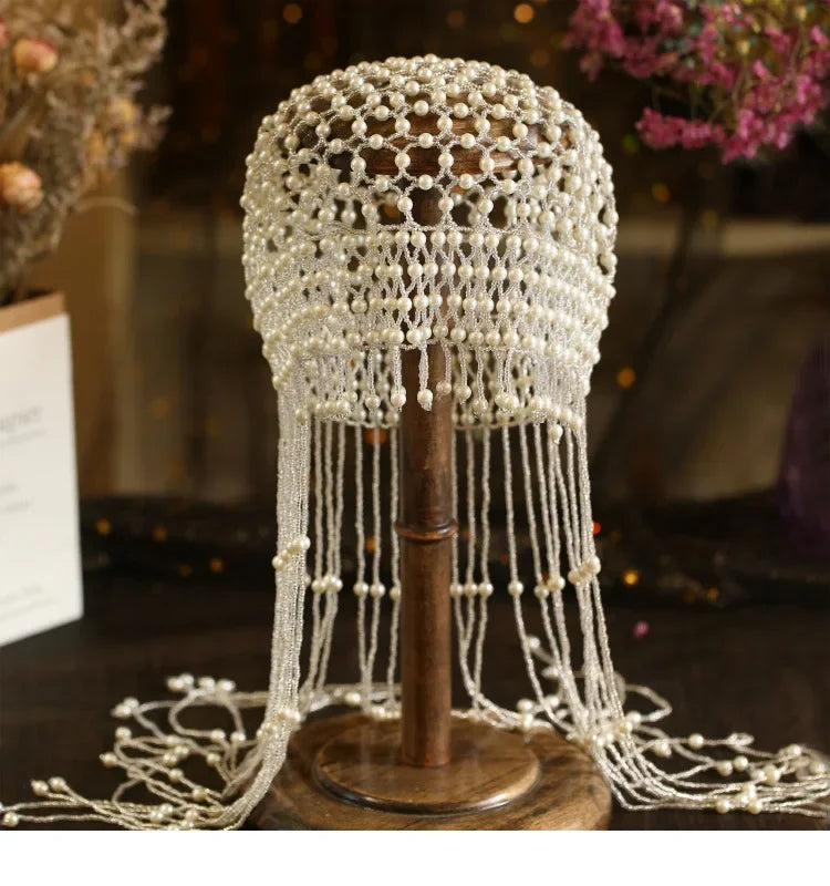 Handmade hollowed-out headpiece with pearl tassels, performance hat by eprolo featuring intricate design and elegant style.