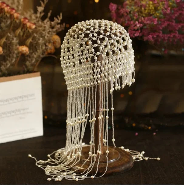 Handmade hollowed-out headpiece with pearl tassels, performance hat by eprolo, featuring intricate design and elegant details.