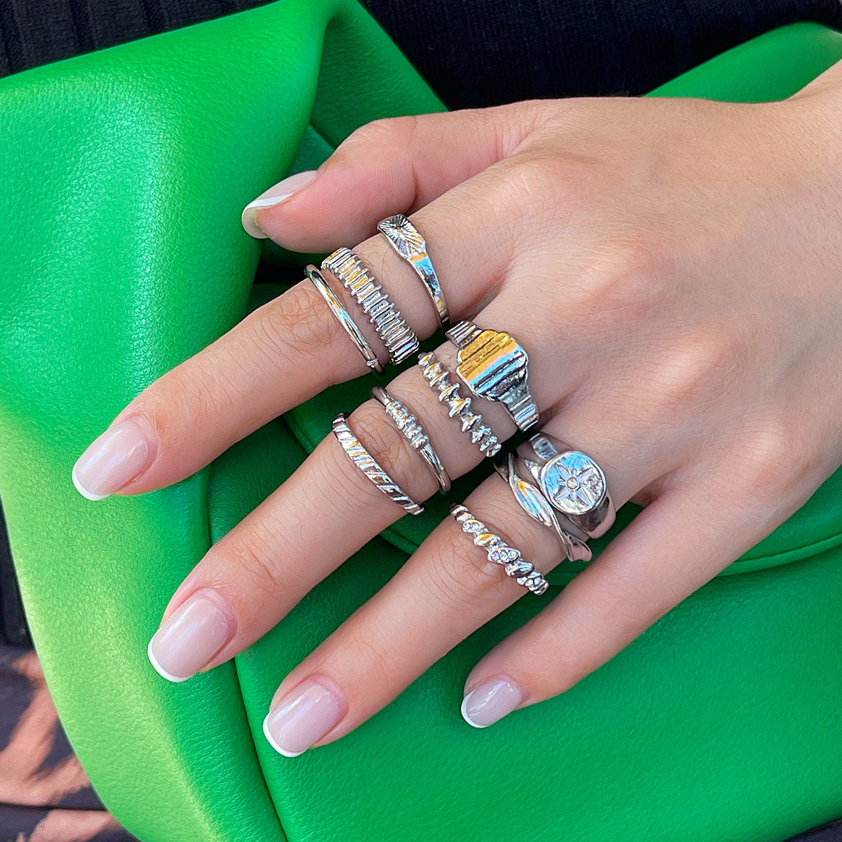 Vintage irregular gear ring with diamond setting and metallic geometric rings, showcasing unique, versatile jewelry design by eprolo.