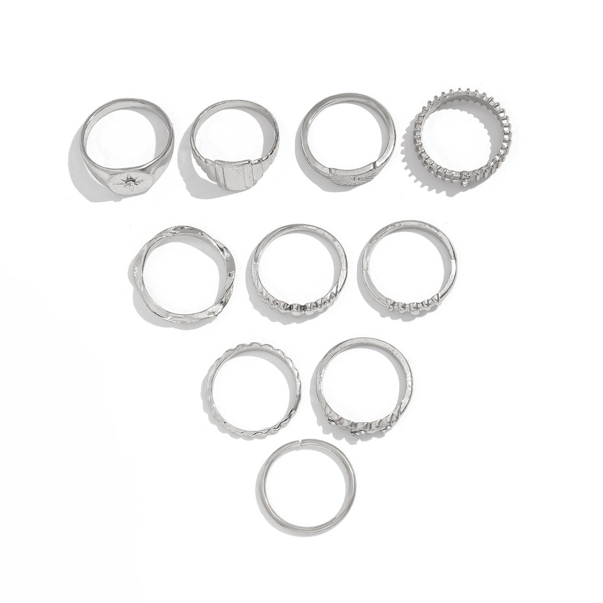 Vintage eprolo gear ring with irregular design and diamond accents, paired with metallic geometric rings for a versatile jewelry look.
