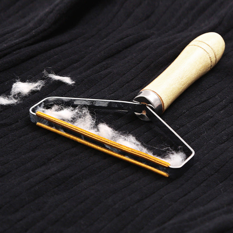 Eprolo wooden handle double-sided lint remover tool for clothes showing the brush surface and wooden grip.