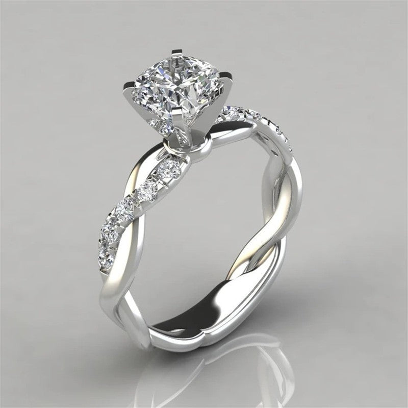 Eprolo 18k rose gold plated two-tone princess square diamond ring with cross twist design and sparkling diamonds.