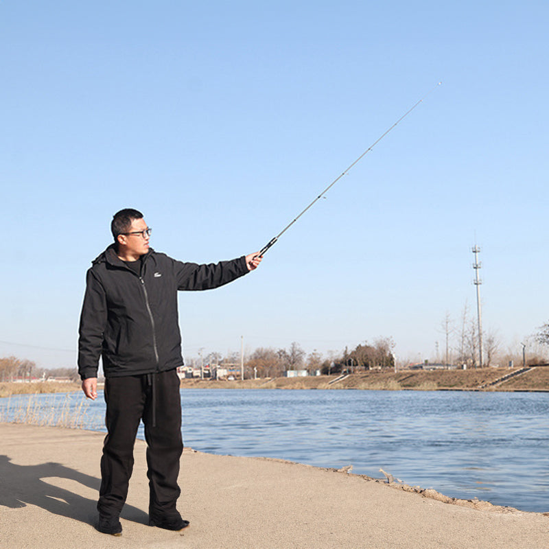 Portable ultra-short carbon fiber telescopic fishing rod in black with adjustable length options, ideal for sea fishing.