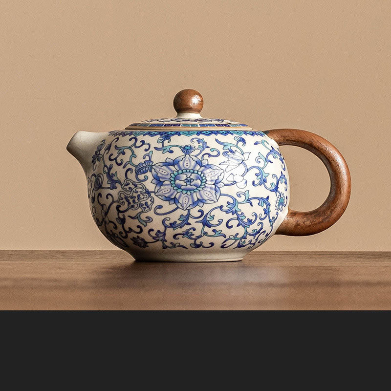 Blue and white ceramic Kung Fu tea set with lotus design, including tea pot, fair cup, tea can, lid, and bowl.