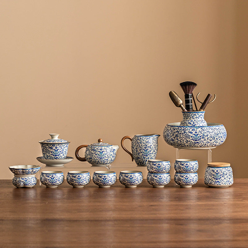 Blue and white ceramic Kung Fu tea set with lotus design, including teapot, fair cup, tea can, lid, and bowl.
