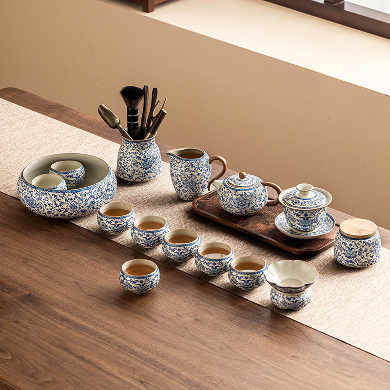 Blue and white ceramic Kung Fu tea set with lotus design, including teapot, fair cup, lid, and bowl for traditional tea brewing.