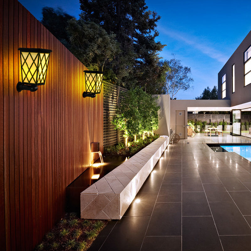 Eprolo solar LED flame light outdoor garden wall lamp illuminating villa lawn with warm, flickering flame effect.