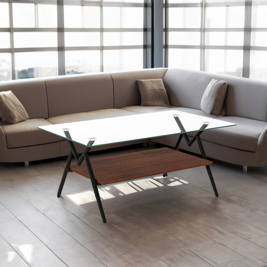 Rectangular modern coffee table with transparent tempered glass top and black metal legs for living room decor.